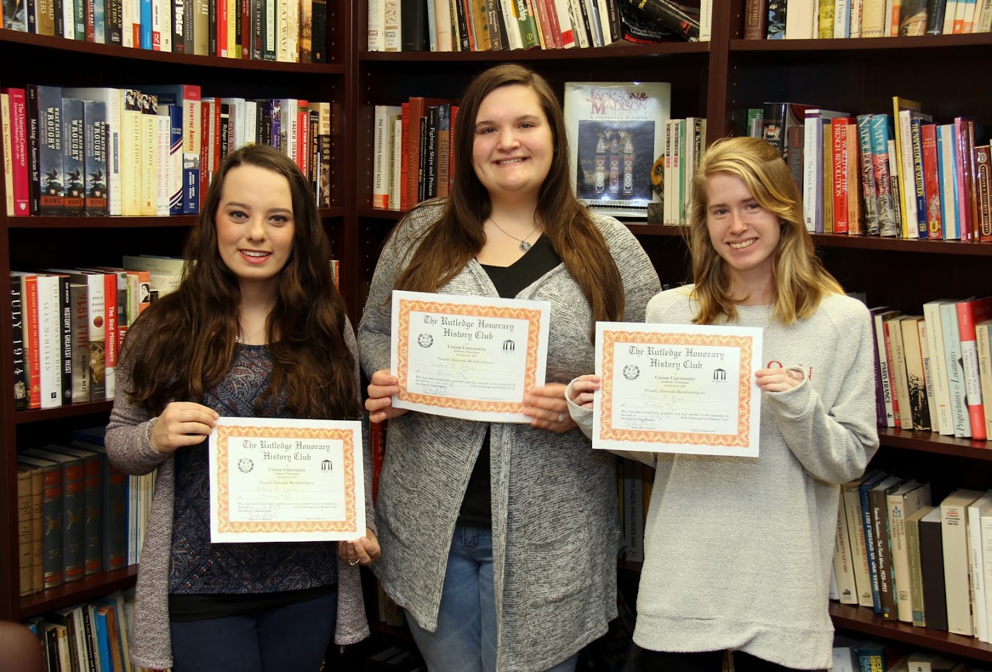The Rutledge Honorary History Club's fall semester initiates hold their membership certificates in Dr. Stephen Carls's office. They are (left to right) Ashley Lovins, Sandra Allen, and Taylor Brown.