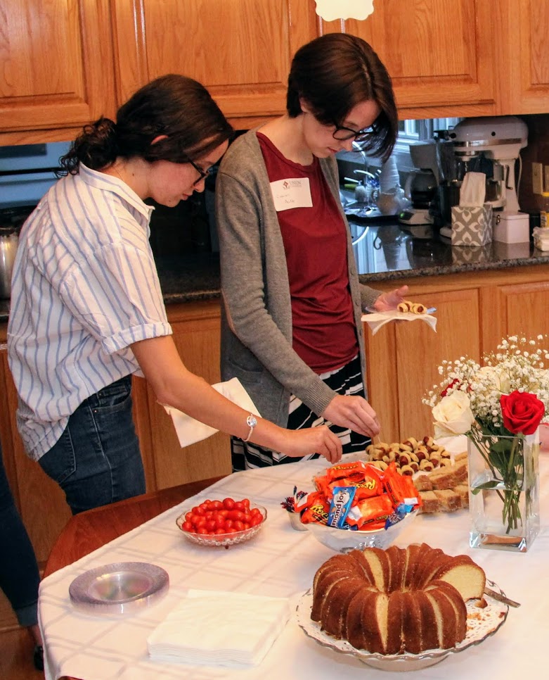 Lillie Salazar (left) and Lauren Butler go through the food line at the History Welcome Reception on September 10, 2018.