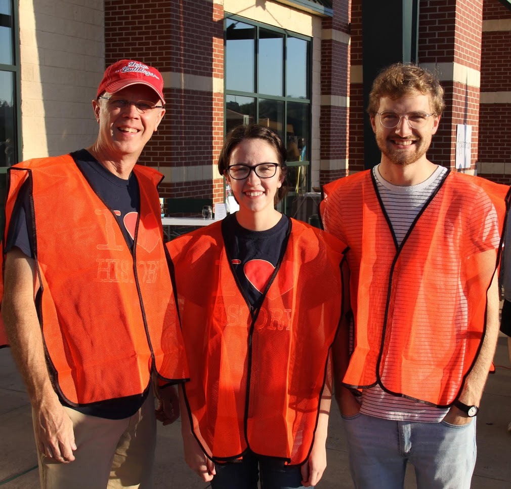 Robert Briley (left to right), Lauren Butler, and Luke Sower show off their safety vests as Phi Alpha Theta volunteers at the Racing So They Can Ride 5k and 10k fundraising races on September 15, 2018.
