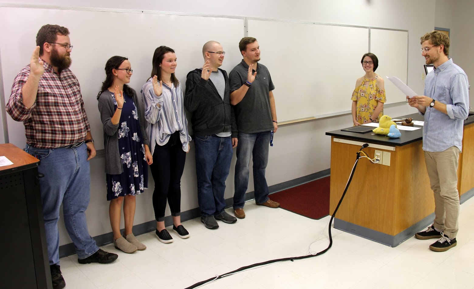 Delta-Psi Chapter Vice President Luke Sower leads the Phi Alpha Theta induction ceremony - while President Lauren Butler (second from right) observes - at the chapter's plenary meeting on September 20, 2018. The inductees are (left to right) Christopher Hearn, Lillie Salazar, Audrey Cagle, Will Choate, and Macon Bullock.