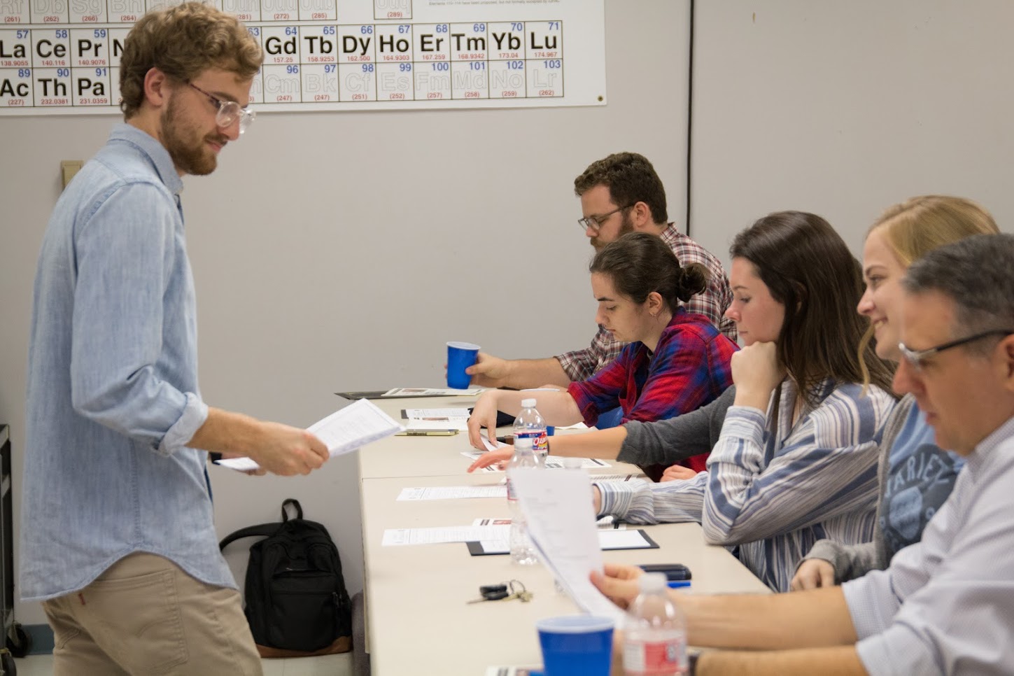 Delta-Psi Chapter Vice President Luke Sower hands out Phi Alpha Theta fact sheets to society members at the chapter's fall plenary meeting on September 20, 2018. Seated are (back to front) Christopher Hearn, Leah Atkins, Audrey Cagle, Megan Ledbetter, and Dr. Keith Bates. Photo by Lynn Tucker