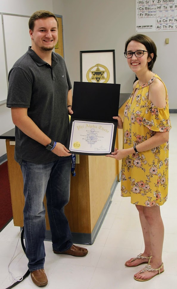 Delta-Psi President Lauren Butler presents Macon Bullock with his Phi Alpha Theta membership certificate on September 20, 2018.