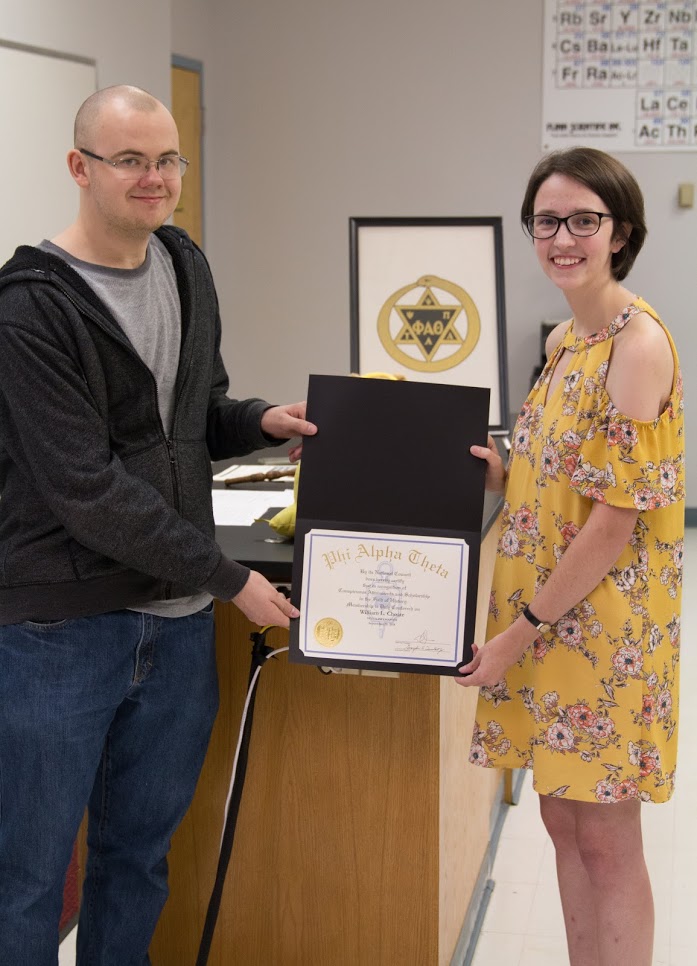 Will Choate accepts his Phi Alpha Theta membership certificate from Delta-Psi Chapter President Lauren Butler on September 20, 2018. Photo by Lynn Tucker