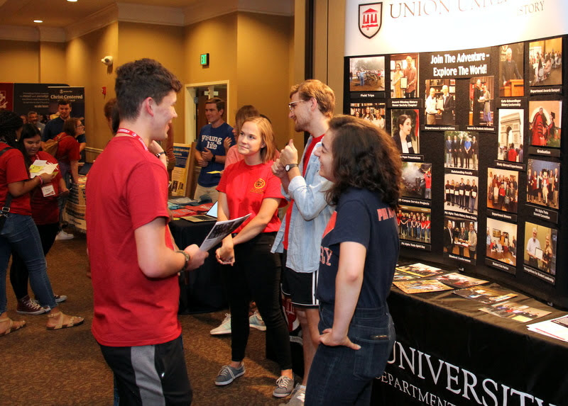 History student club officers greet new students at the history department display table during the Campus Life Fair on August 18. They are: (left to right, with the display at their backs) Megan Ledbetter, Phi Alpha Theta vice president; Luke Sower, Phi Alpha Theta president; and Leah Atkins, Rutledge Honorary History Club president.