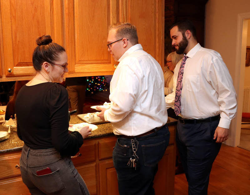 Attendees at the French Christmas dinner on December 7, 2019, go through the dessert line. They are (left to right) Katie Allison, Nathan Heatherly, and Nicholas Terra.