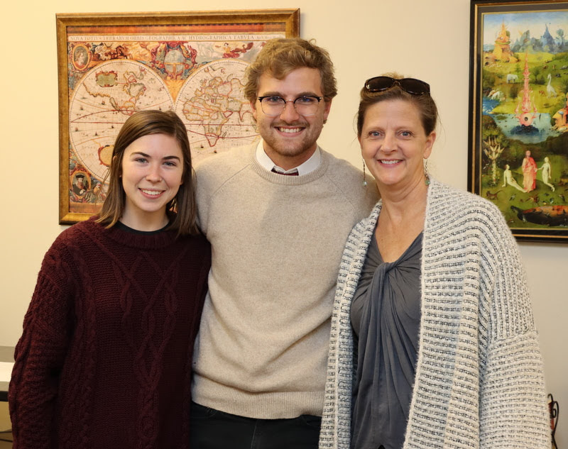 Luke Sower stands with his wife Brittany (left) and his mother Rebecca prior to his history honors thesis defense on December 3, 2019.