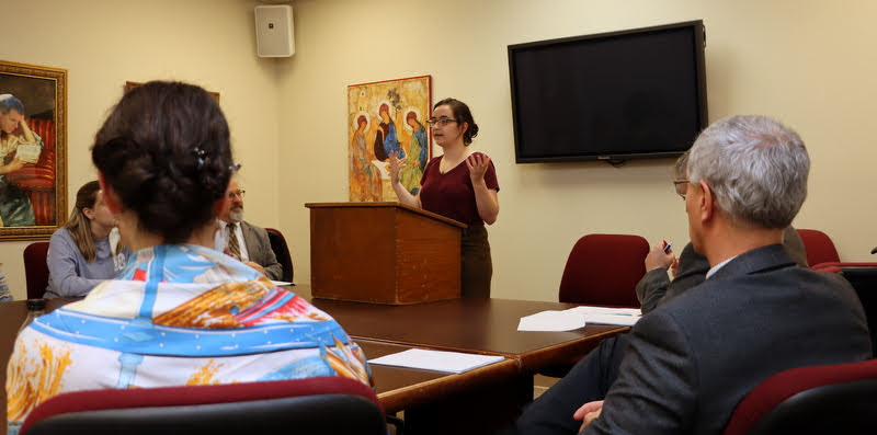 Attendees listen to Leah Atkins discuss her honors thesis on Poisonous Women in ancient Rome during her thesis defense on December 9, 2019.