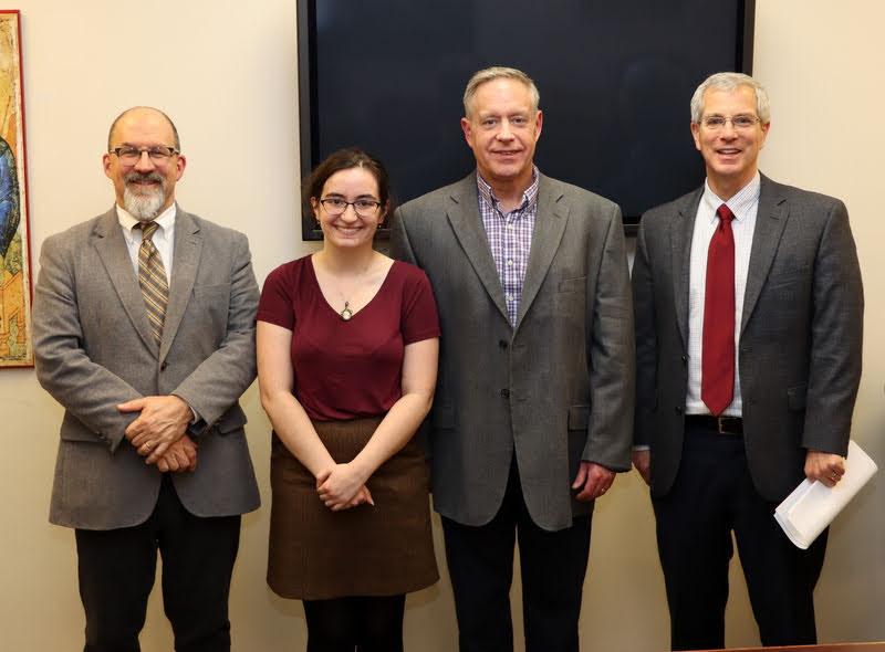 Leah Atkins stands with her history honors thesis committee after her successful thesis defense on December 9, 2019. The committee members are (left to right) Dr. Scott Huelin, Dr. Henry Allen, the thesis committee chair, and Dr. David Thomas.