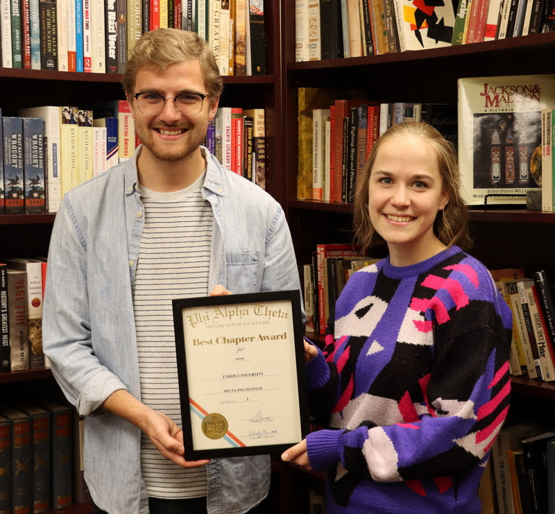 Delta-Psi Chapter President Luke Sower and Vice President Megan Ledbetter hold the 2019 Phi Alpha Theta Best Chapter Award certificate on November 5, 2019. The document arrived at Union on October 31.