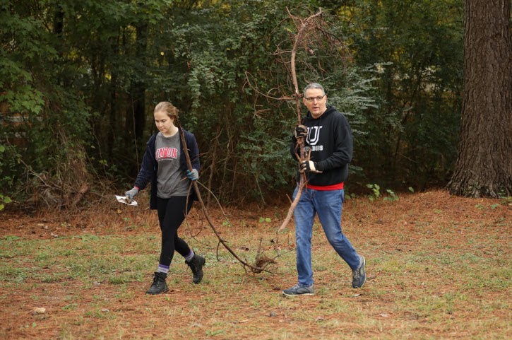 Megan Ledbetter and Dr. Keith Bates remove dead branches from a wooded area of Liberty Garden Park on October 29, 2019. Photo by Kristi Woody