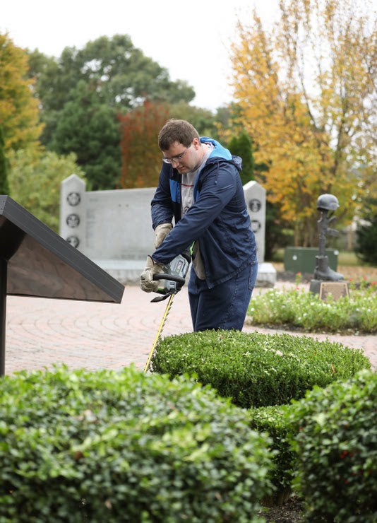 Miles Randall trims shrubs at the Freedom Plaza of Liberty Garden Park and Arboretum on October 29, 2019. Photo by Kristi Woody