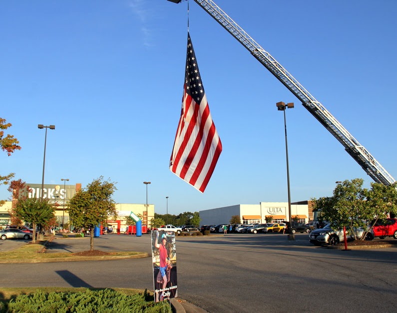 An American flag marks the entry point to the Racing So They Can Ride 5k and 10k races at Dick's Sporting Goods on September 21, 2019.