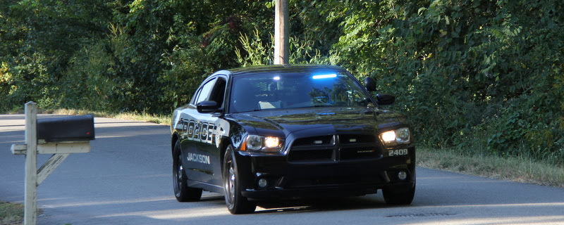 A City of Jackson police car provides protection for the runners in the Racing So They Can Ride races on September 21, 2019.