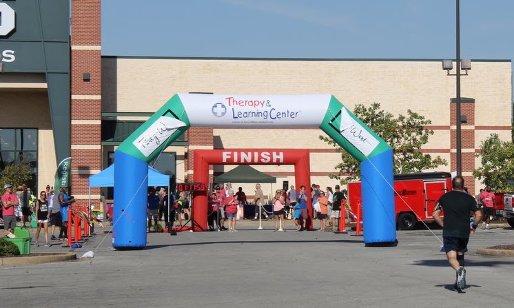 A runner approaches the finish line in the 10k race at the Racing So They Can Ride event on September 21, 2019.
