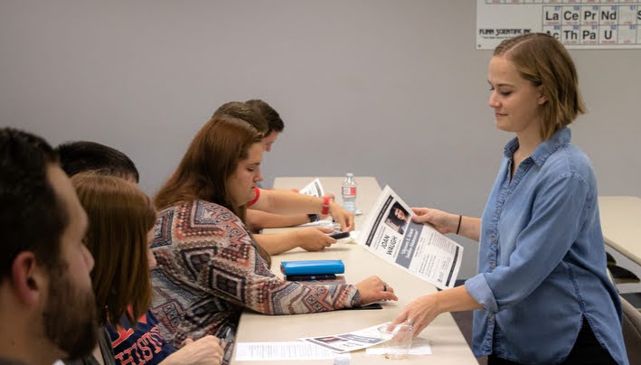 Phi Alpha Theta Vice President Megan Lebetter distributes flyers for the 2019 Carls-Schwerdfeger History Lectureship at the plenary meeting of the Delta-Psi chapter on September 24, 2019. Photo by Joey Echeverria