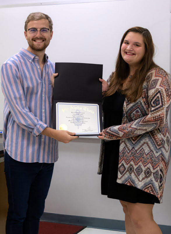 Sandra Allen accepts her Phi Alpha Theta membership certificate from Luke Sower on September 24, 2019. Photo by Joey Echeverria