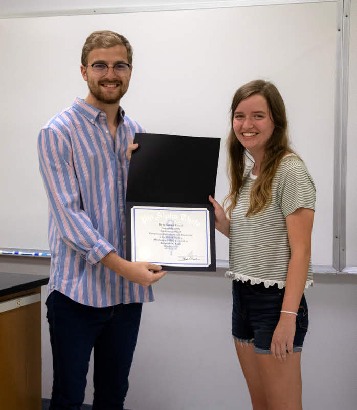 Delta-Psi Chapter President Luke Sower presents Rebekah Lisle with her Phi Alpha Theta membership certificate at the chapter's fall initiation/plenary meeting on September 24, 2019. Photo by Joey Echeverria
