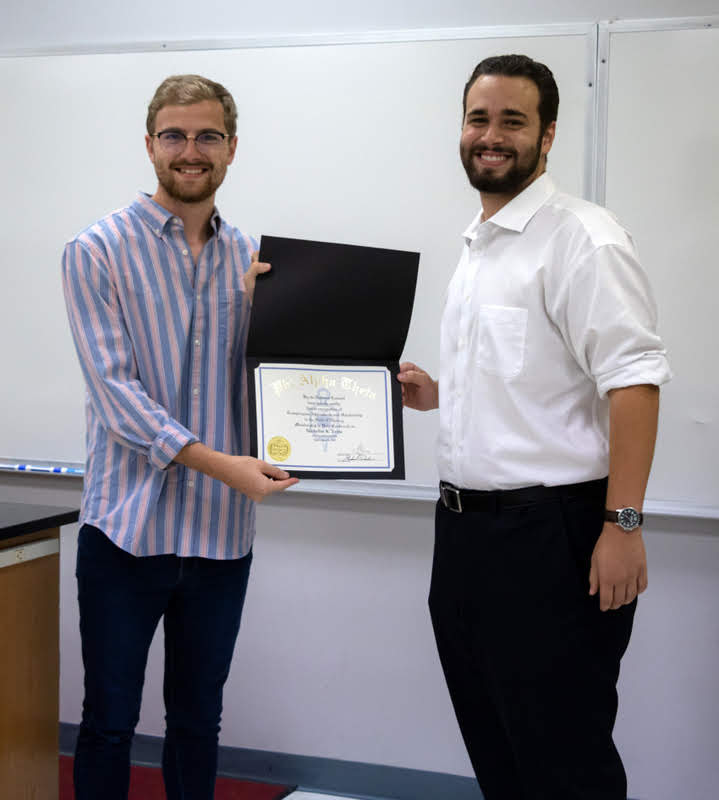 Nicholas Terra (right) accepts his Phi Alpha Theta membership certificate from Delta-Psi Chapter President Luke Sower at the chapter's fall plenary meeting on September 24, 2019. Photo by Joey Echeverria