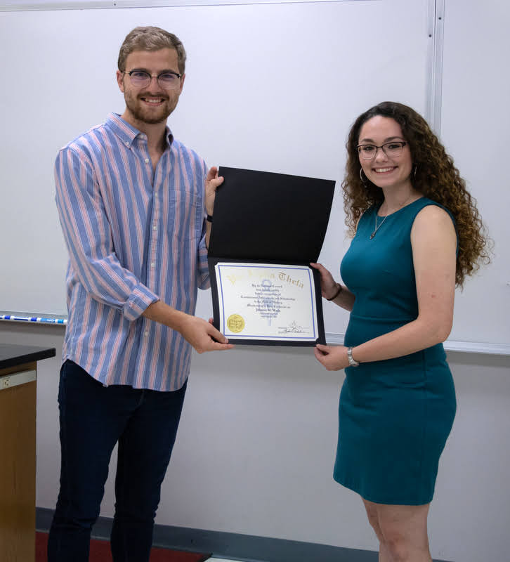 Delta-Psi President Luke Sower presents Johnna Wade with her Phi Alpha Theta certificate of membership on September 24, 2019. Photo by Joey Echeverria
