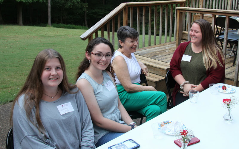Student attendees enjoy a moment with Dr. Alice-Catherine Carls (second from right) at the History Welcome Reception on September 9, 2019. The students are (left to right) Hannah Ratliff, Johnna Wade, and Willow Martindale.