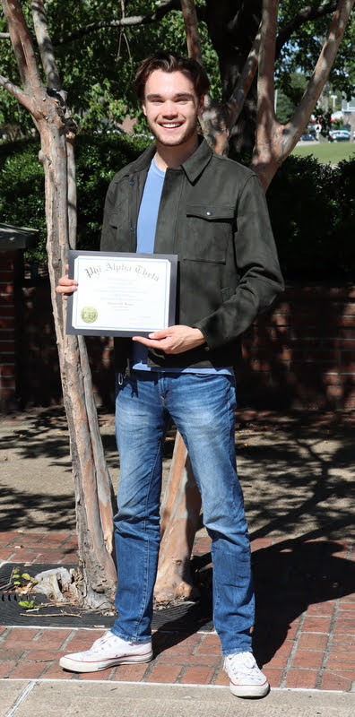 Jack Waters displays his Phi Alpha Theta membership certificate during the outdoor part of the Delta-Psi chapter's plenary meeting on September 30, 2020.