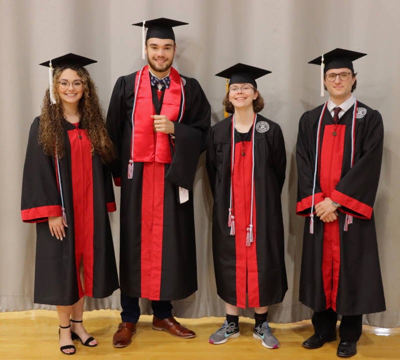 Graduating history students who are also Phi Alpha Theta members join together for a photo prior to Union University's fall commencement on December 11, 2021. They are (left to right) Johnna Wade (history major), Jack Waters (history major), Elizabeth Blevins (history major), and Joe Gee (history minor).