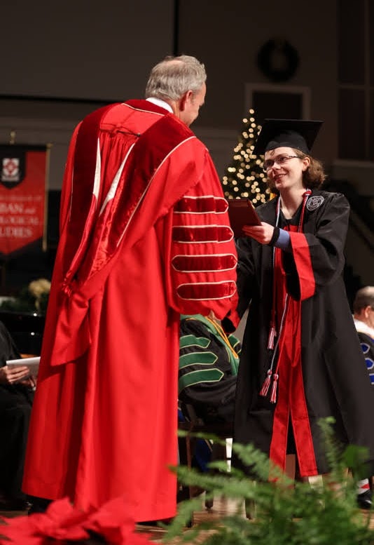 History major Elizabeth Blevins accepts her B.S. diploma from Union University President Samuel W. Dub Oliver at the school's fall graduation exercises on December 11, 2021. Photo by Kristi Woody