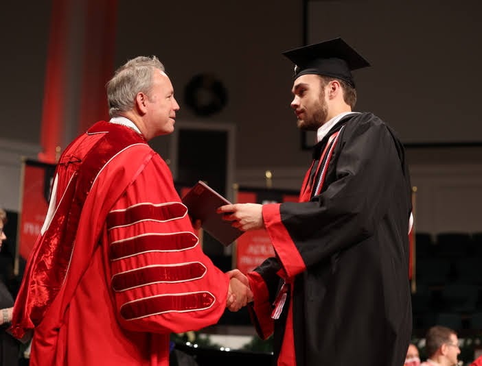 History major Jack Waters accepts his B.A. diploma from Union University President Samuel W. Dub Oliver at the school's fall commencement on December 11, 2021. Photo by Kristi Woody