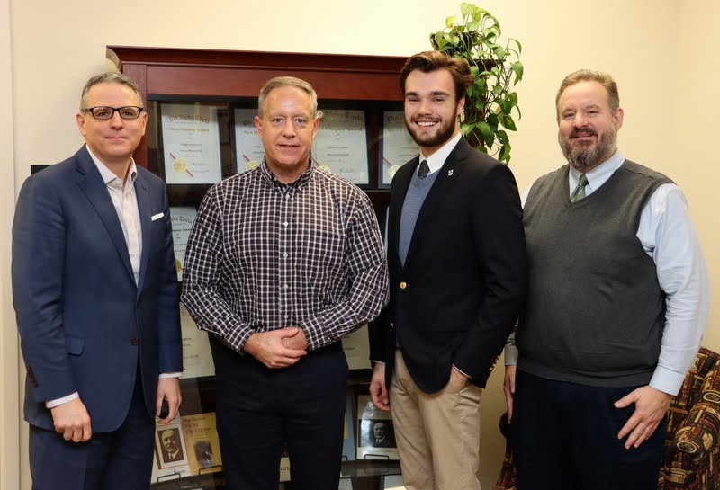 Jack Waters (second from right) stands with his faculty thesis committee following his successful thesis defense on December 8, 2021. The faculty committee members are (left to right) Dr. Keith Bates, Dr. Henry Allen (Waters' thesis advisor), and Mike Garrett of the Ryan Center for Biblical Studies.
