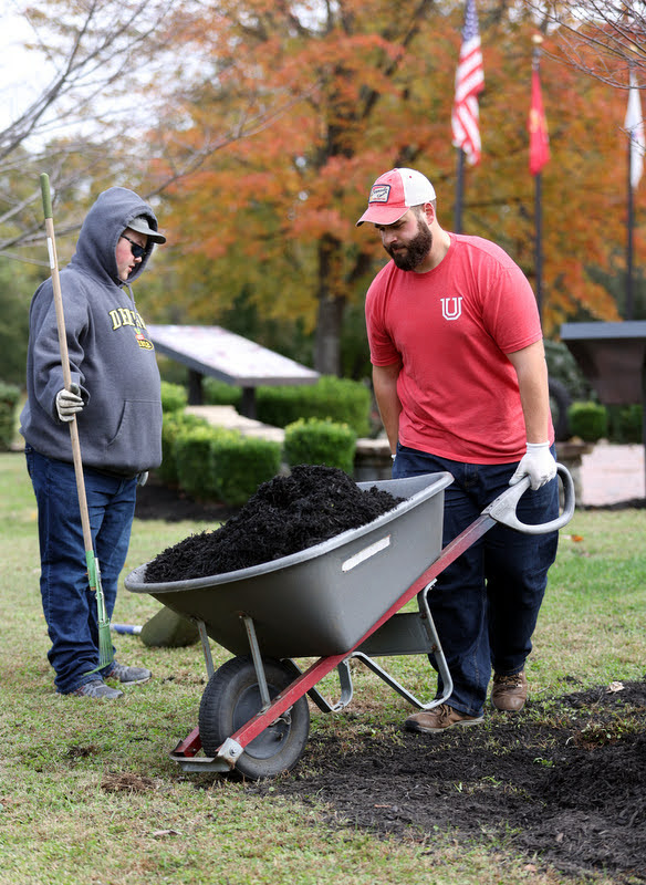 Union students Logan Sherrod (left) and Nick Terra work together mulching a shrubbery area at Liberty Garden Park on November 2, 2021. Photo by Kristi Woody