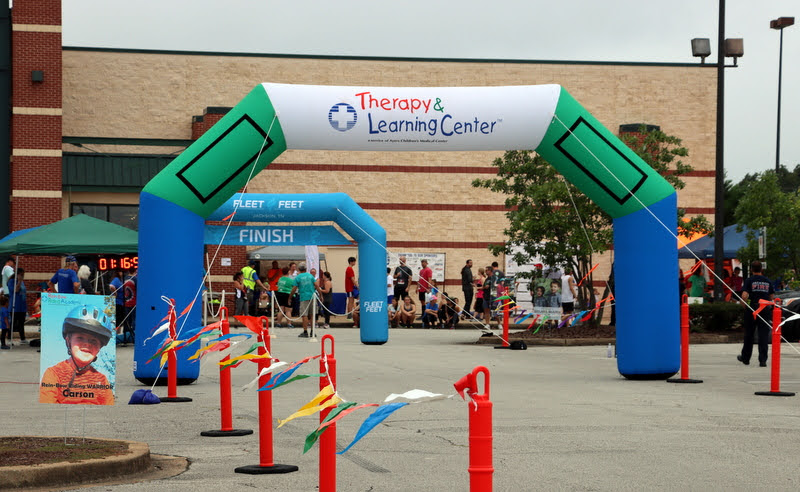 The area of the start and finish lines for the Racing So They Can Ride races at Dick's Sporting Goods is a cheerful sight for participating runners and walkers on September 18, 2021.