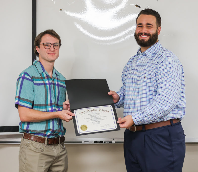 Joe Gee (left) receives his Phi Alpha Theta membership certificate from Delta-Psi President Nick Terra at the Delta-Psi chapter's plenary meeting on September 27, 2021. Photo by Kristi Woody