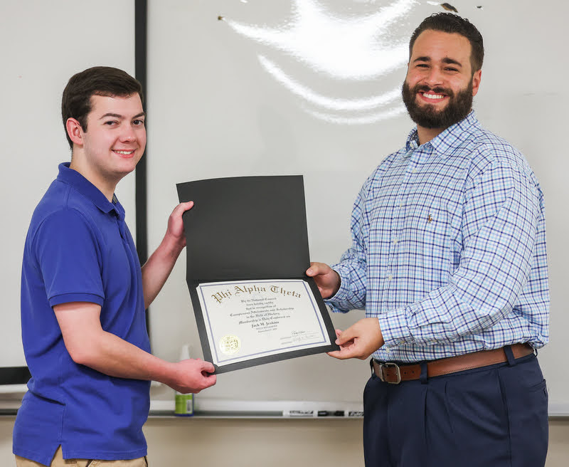 Jack Jenkins (left) accepts his Phi Alpha Theta membership certificate from Delta-Psi President Nick Terra at the chapter's plenary meeting on September 27, 2021. Photo by Kristi Woody