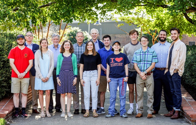 Members of Union University's Delta-Psi chapter of Phi Alpha Theta stand together near the school's fountain on September 27, 2021. They are (front row, left to right) Walker Beasley, Anna Yadkowski, Anne Adams, Abbie Hobson, Elizabeth Blevins, Joe Gee, and Jack Waters; (back row, left to right) Dr. Keith Bates, Dr. Terry Lindley, Dr. Henry Allen, Dr. Stephen Carls, Jack Jenkins, Tad Binkley, and Nick Terra. Photo by Kristi Woody