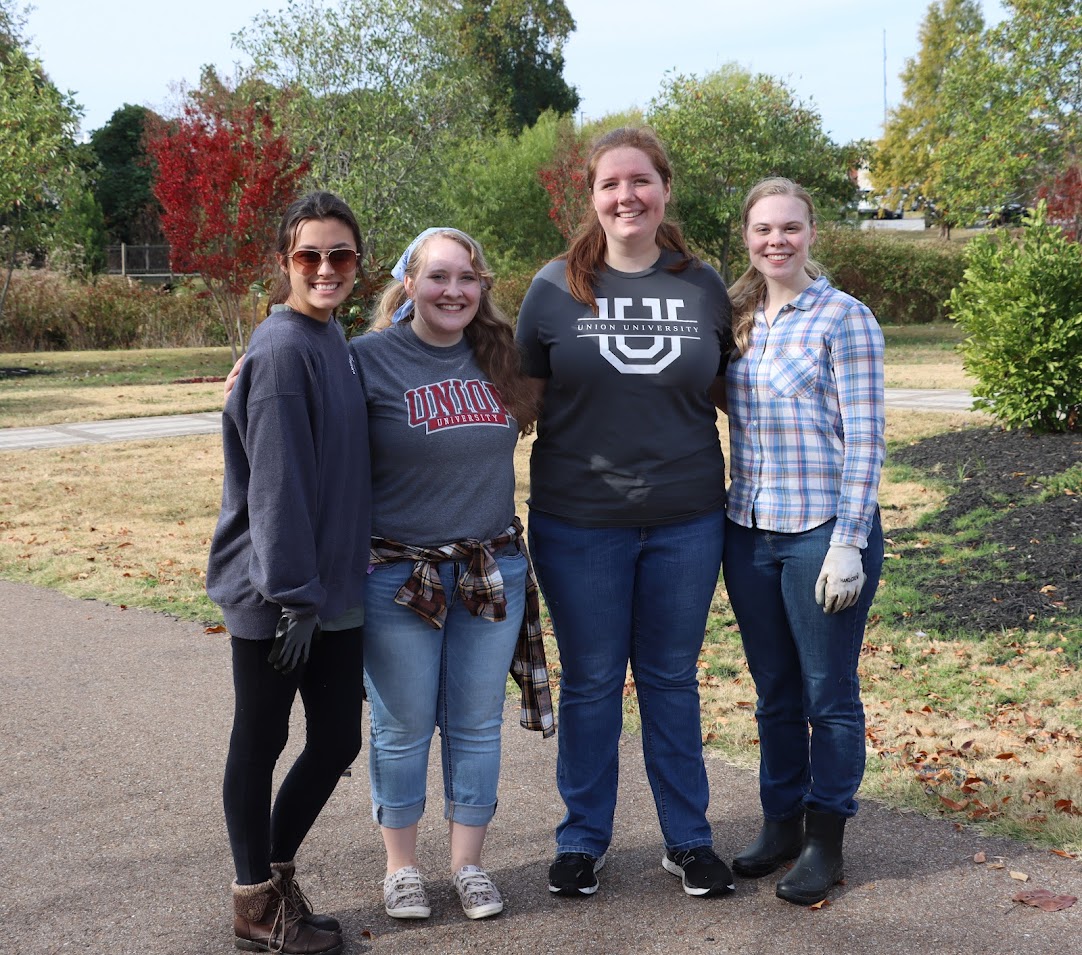 Union University students take a break from their volunteer work at Liberty Garden Park on November 1, 2022. They are (left to right) Makayla Baker, Breanna Edmiston, Abigail Gilbert, and Anna Guelcher.