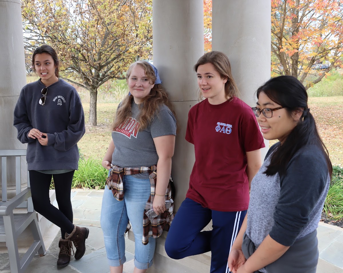 Phi Alpha Theta members (left to right) Makayla Baker, Breanna Edmiston, Anna Yadkowski, and Lydia McGinnis relax during the closing ceremony of the community service project at Liberty Garden Park on November 1, 2022.