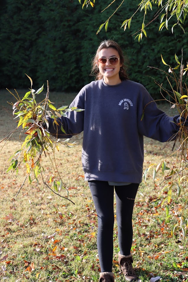 Phi Alpha Theta member Makayla Baker gathers up branches at Liberty Garden Park  during the history department's community service project there on November 1, 2022.