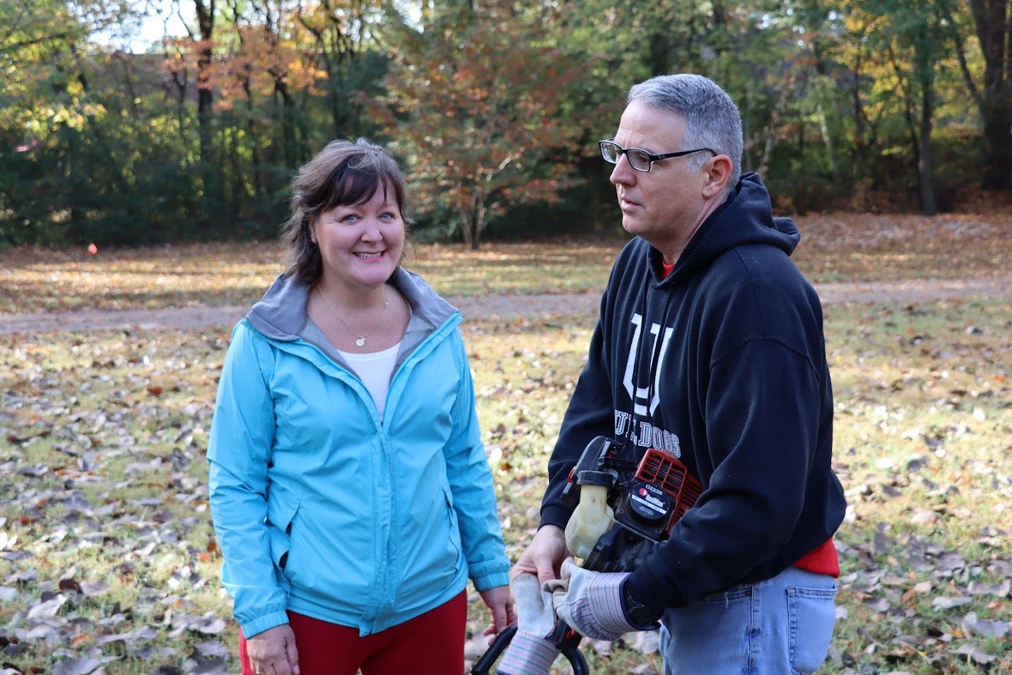 Tammy Buchanan-Anderson stands with Dr. Keith Bates as he prepares to do some grass trimming at Liberty Garden Park on November 1, 2022.