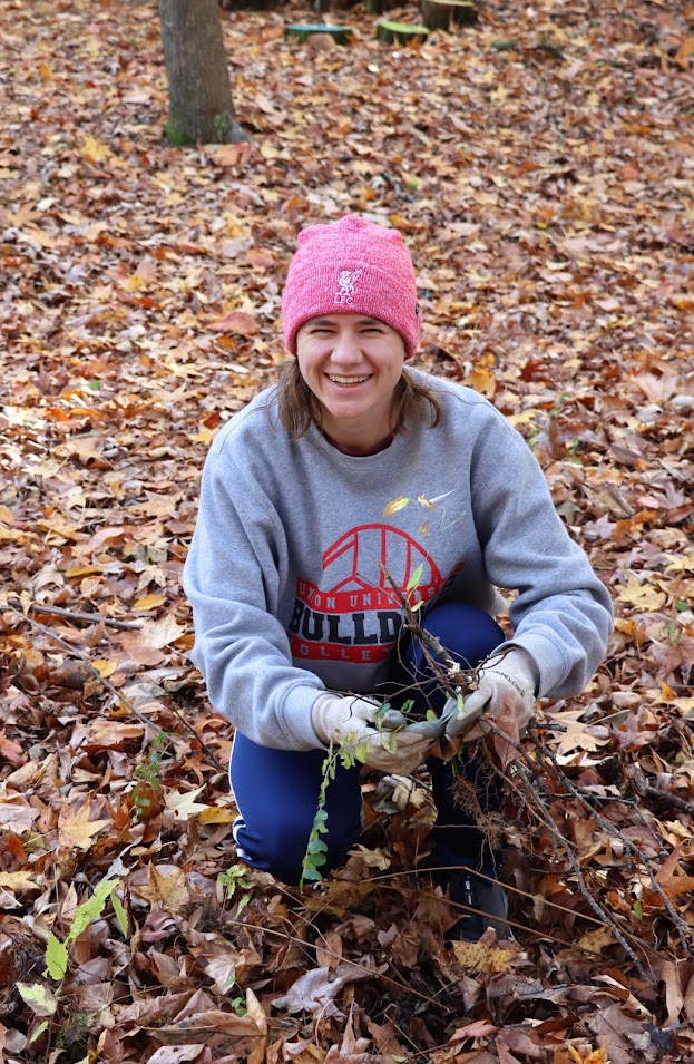 Anna Yadkowski gathers up twigs and branches at the history department's community service project at Liberty Garden Park on November 1, 2022.