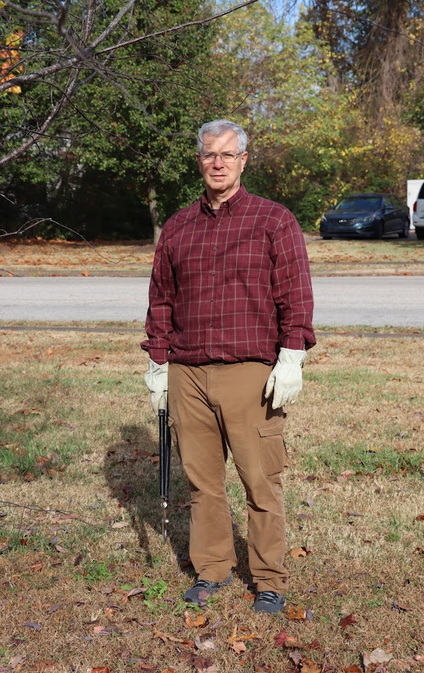 Dr. David Thomas takes a break from tree trimming during the Phi Alpha Theta/history club community service project at Liberty Garden Park on November 1, 2022.