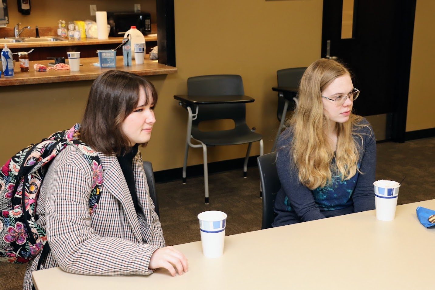 Sophia Keskeys (left) and Anna Guelcher enjoy hot chocolate while waiting for the history club's fall plenary meeting to begin on November 14, 2022.