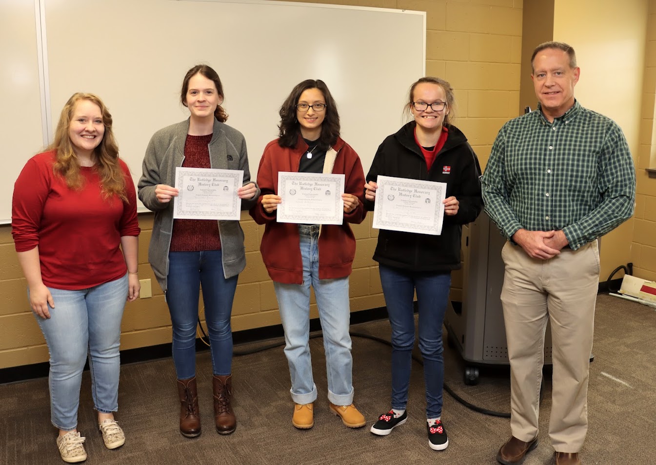 Rutledge Honorary History Club President Breanna Edmiston (left) and Club Faculty Sponsor Dr. Henry Allen (right) stand with new members (left to right) Samantha Poore, Nayelli McDowell, and Katlin Palm-Leis following the initiation ceremony at the club's fall plenary meeting on November 14, 2022.