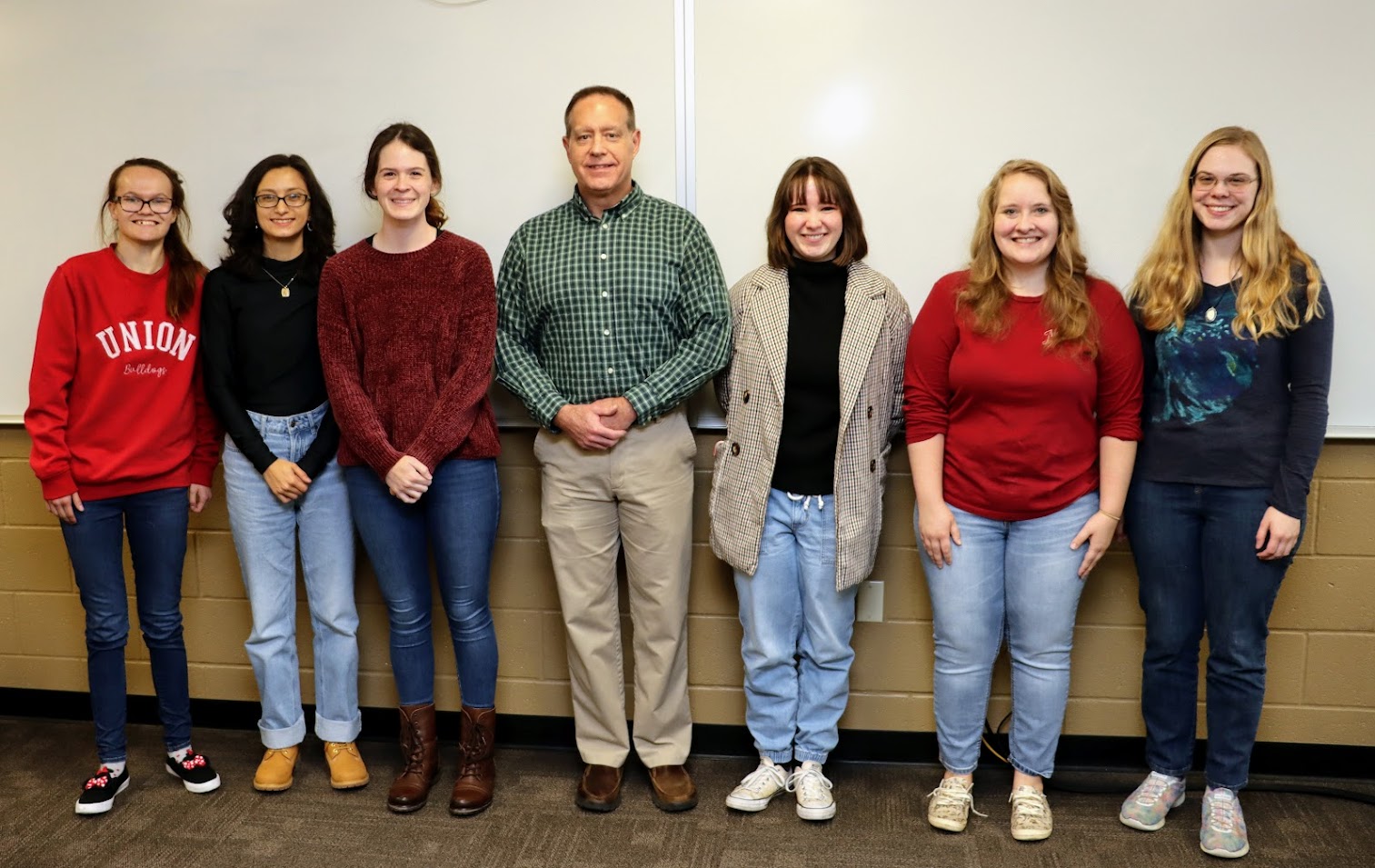 Attendees at the Rutledge Honorary History Club's fall plenary meeting on November 14, 2022, stand for a photo. They are (left to right) Katlin Palm-Leis, Nayelli McDowell, Samantha Poore, Dr. Henry Allen, Sophia Keskeys, Breanna Edmiston, and Anna Guelcher.