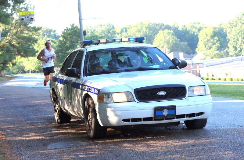 A City of Jackson police vehicle provides safety for the lead runner in the 10k race at the Racing So They Can Ride event on September 17, 2022.