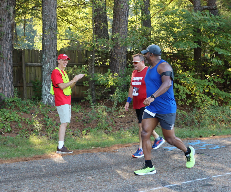 Phi Alpha Theta member Robert Briley cheers on runners in the Racing So They Can Ride races on September 17, 2022.