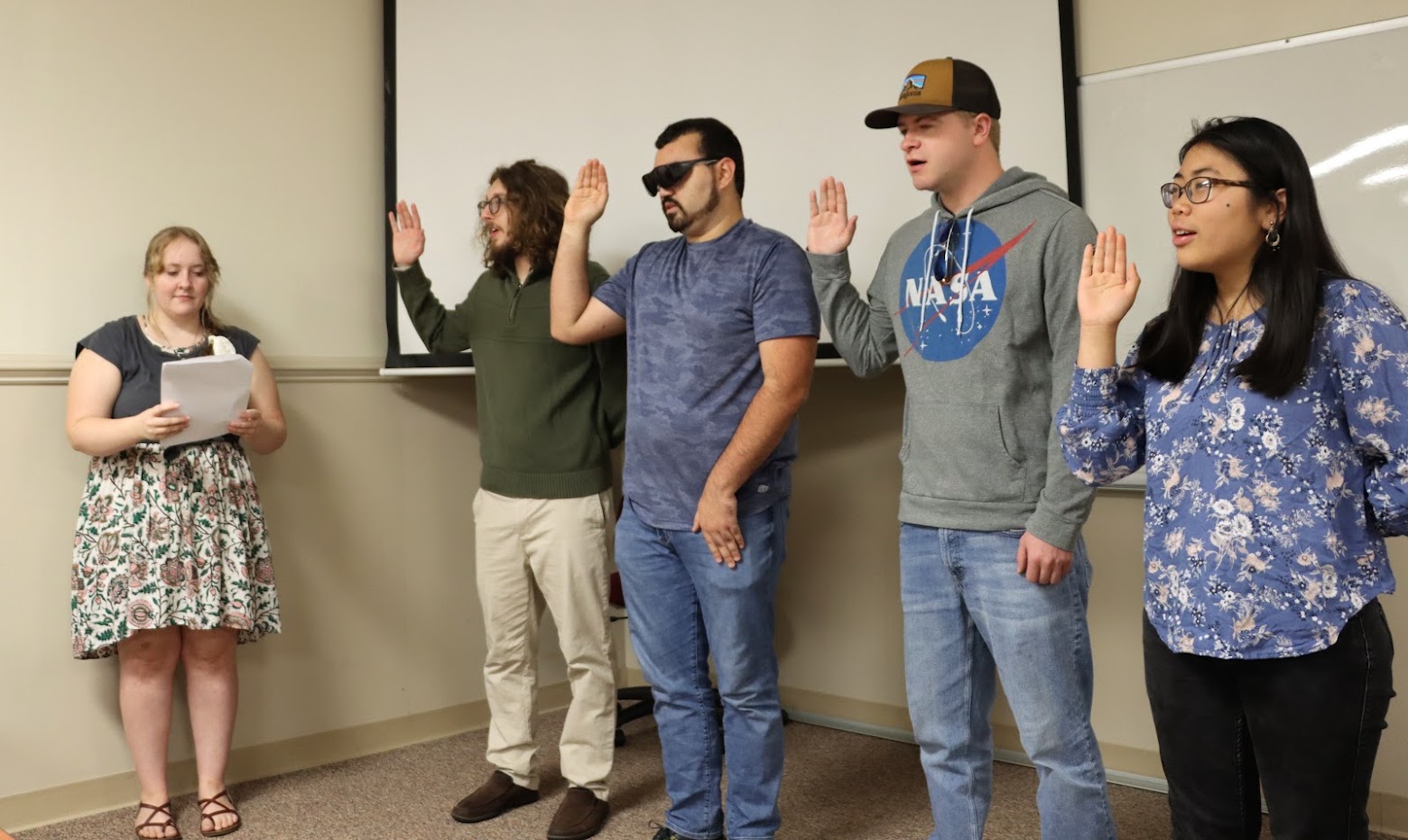 Delta-Psi Vice President Breanna Edmiston (left) conducts the membership oath for the chapter's new Phi Alpha Theta initiates. They are (left to right) Nicholas Palmer, Christian Young, John Garland, and Lydia McGinnis.