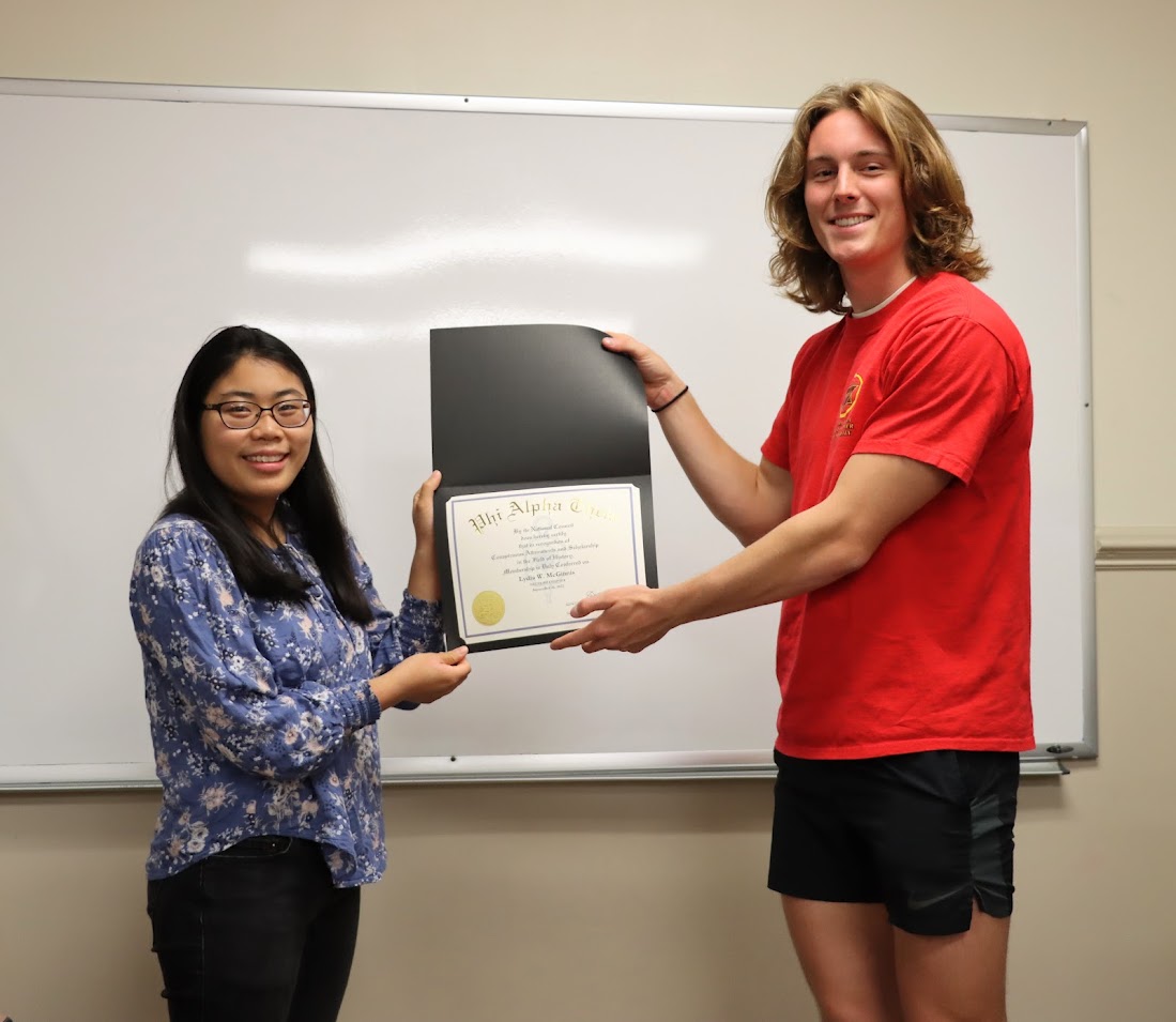 Lydia McGinnis receives her Phi Alpha Theta certificate of membership from Delta-Psi President Tad Binkley on September 26, 2022.