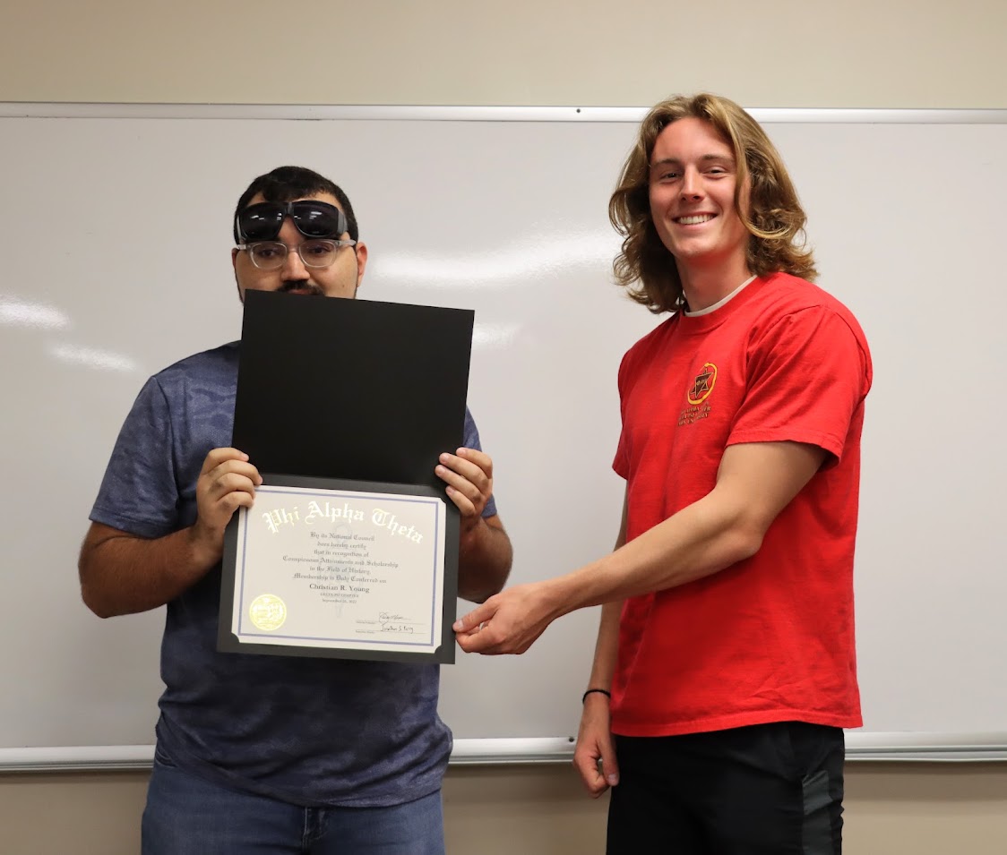 Christian Young (left) receives his Phi Alpha Theta certificate of membership from Delta-Psi Chapter President Tad Binkley on September 26, 2022.