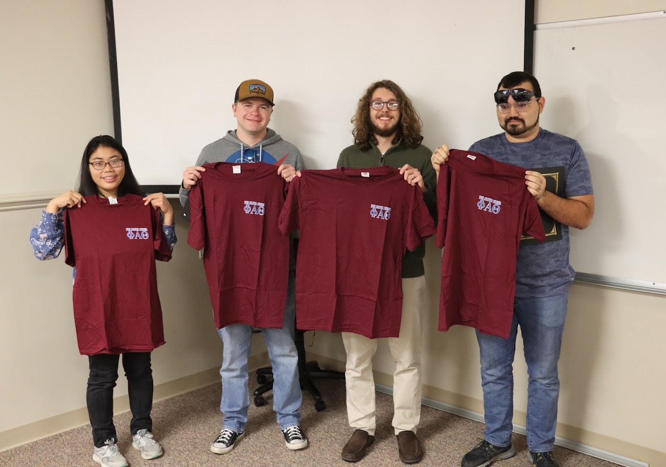 New Delta-Psi chapter members show off the Phi Alpha Theta T-shirts they received at the society's fall plenary meeting on September 26, 2022. They are (left to right) Lydia McGinnis, John Garland, Nicholas Palmer, and Christian Young.