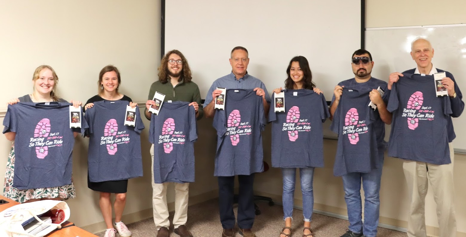 Phi Alpha Theta members display the T-shirts and Lindt chocolate bars they received at the Delta-Psi chapter's plenary meeting on September 26, 2022 for their volunteer work at the 